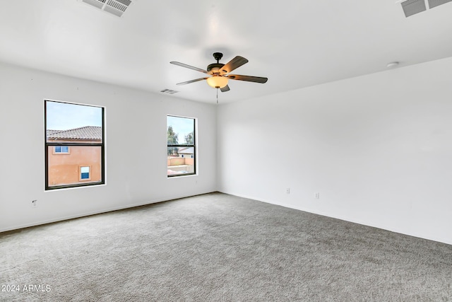 carpeted empty room featuring ceiling fan