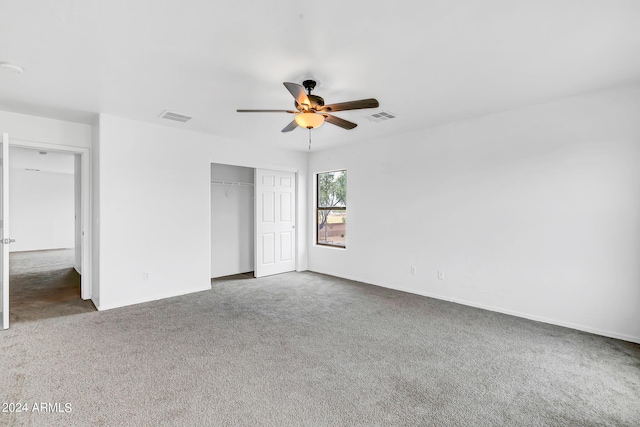 unfurnished bedroom featuring carpet floors, a closet, and ceiling fan