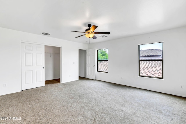 unfurnished bedroom with ceiling fan and carpet floors