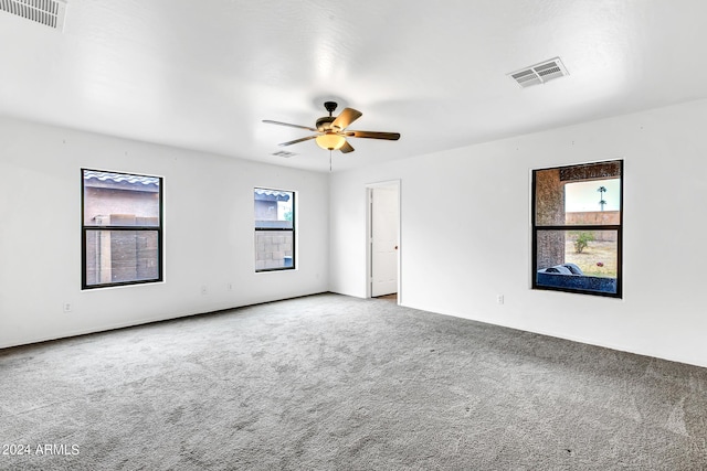 spare room featuring ceiling fan and carpet floors