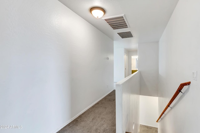 hallway with light colored carpet