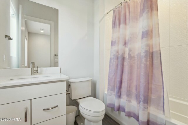 full bathroom with vanity, shower / bath combination with curtain, and toilet