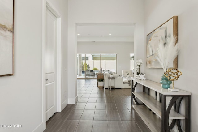 hallway featuring dark tile patterned floors