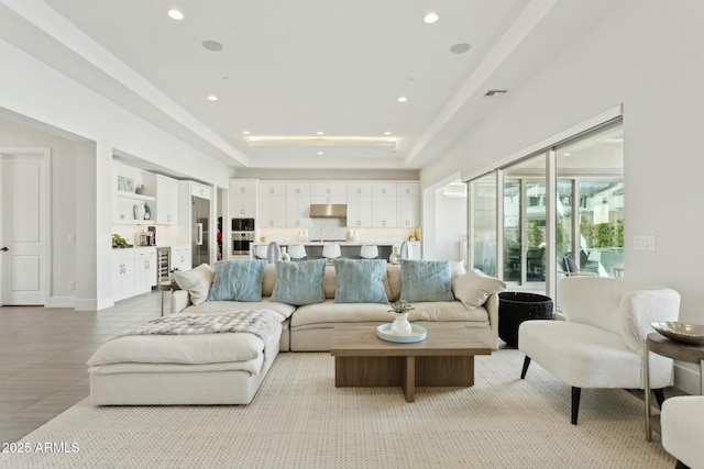 living room featuring a tray ceiling