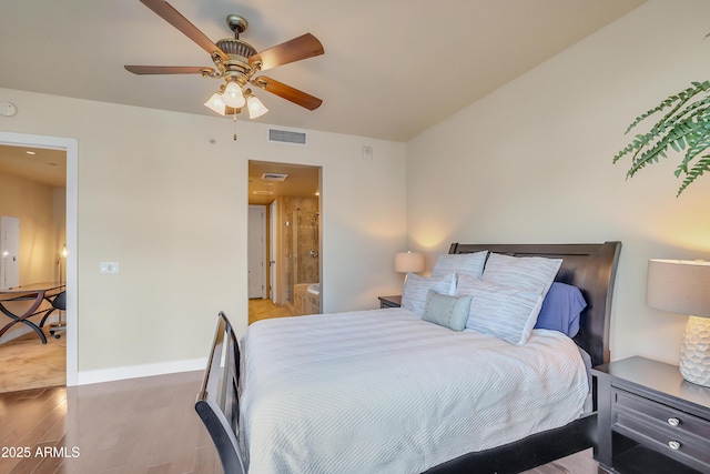 bedroom featuring light wood finished floors, connected bathroom, visible vents, and baseboards