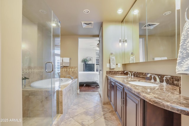 bathroom with double vanity, visible vents, a stall shower, and a sink