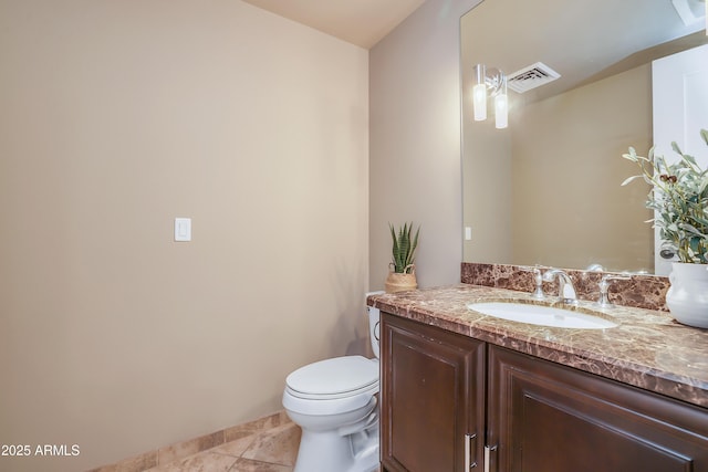half bath with toilet, visible vents, tile patterned flooring, and vanity