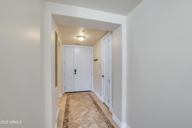 doorway to outside featuring baseboards