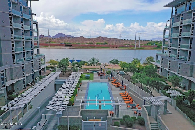 view of pool with a water and mountain view