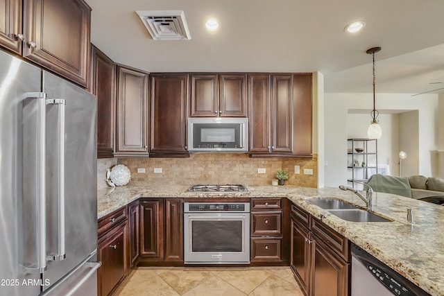 kitchen with a sink, stainless steel appliances, visible vents, decorative backsplash, and light tile patterned floors