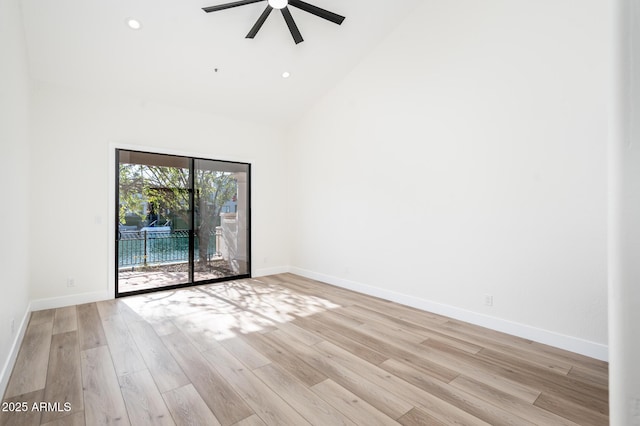 spare room with high vaulted ceiling, light hardwood / wood-style flooring, and ceiling fan