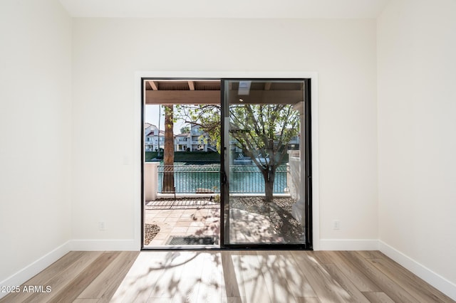 spare room with light hardwood / wood-style flooring