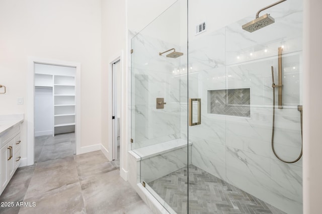 bathroom featuring an enclosed shower and vanity