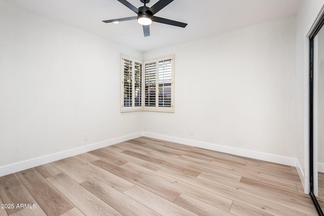 empty room featuring ceiling fan and light hardwood / wood-style flooring