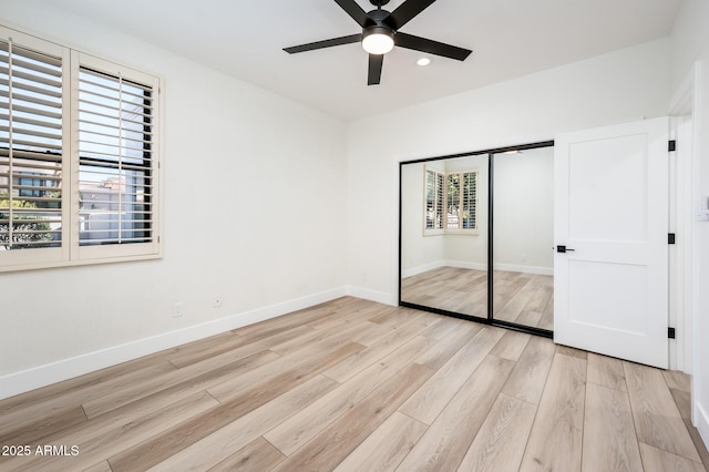 unfurnished bedroom featuring ceiling fan, a closet, and light hardwood / wood-style floors