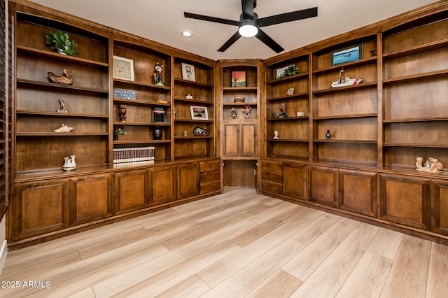 unfurnished office with ceiling fan and light wood-type flooring