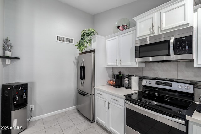6701 W Catalina Dr, Phoenix, AZ 85033 - kitchen featuring light countertops, white cabinets, stainless steel appliances, and visible vents