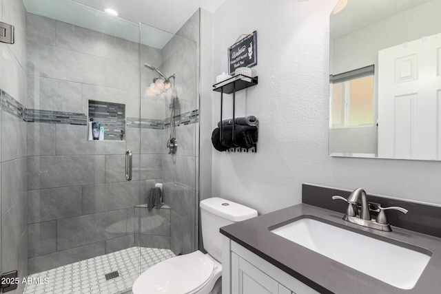 6701 W Catalina Dr, Phoenix, AZ 85033 - bathroom featuring vanity, toilet, and a stall shower