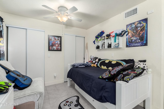 6701 W Catalina Dr, Phoenix, AZ 85033 - bedroom with visible vents, baseboards, ceiling fan, and light tile patterned floors