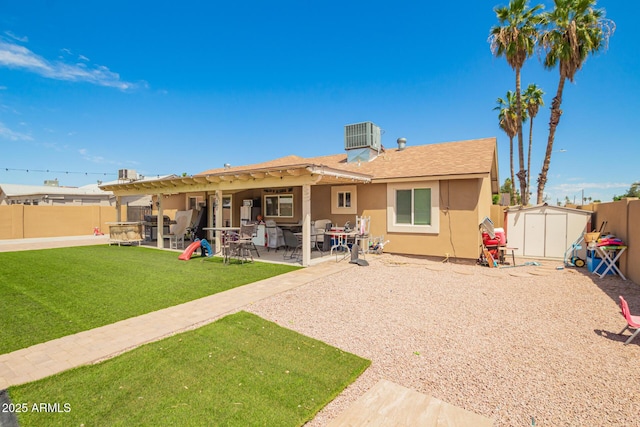6701 W Catalina Dr, Phoenix, AZ 85033 - rear view of property featuring central AC, stucco siding, a shed, a fenced backyard, and an outbuilding