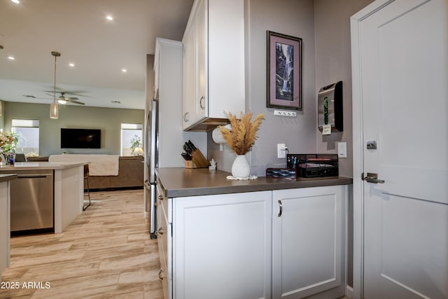 kitchen with ceiling fan, a wealth of natural light, white cabinets, and appliances with stainless steel finishes