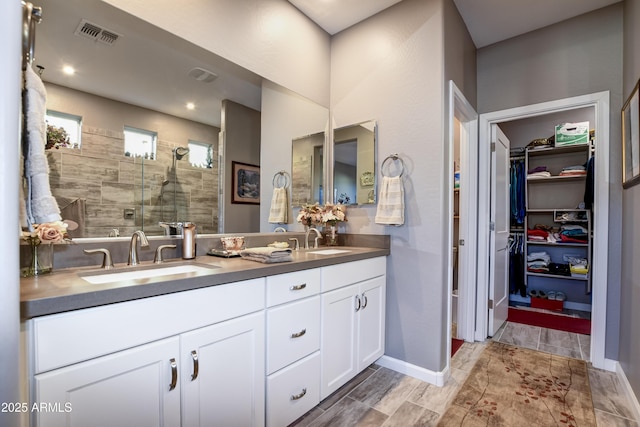 bathroom with vanity and a shower with shower door