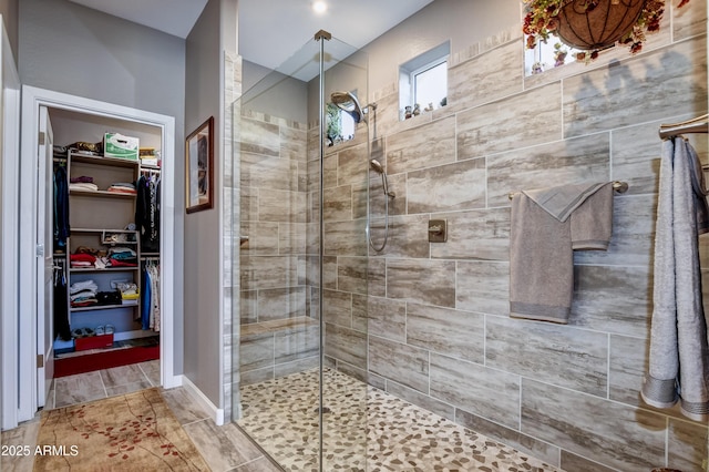 bathroom featuring a shower with door