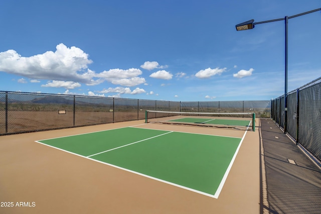 view of sport court with basketball hoop