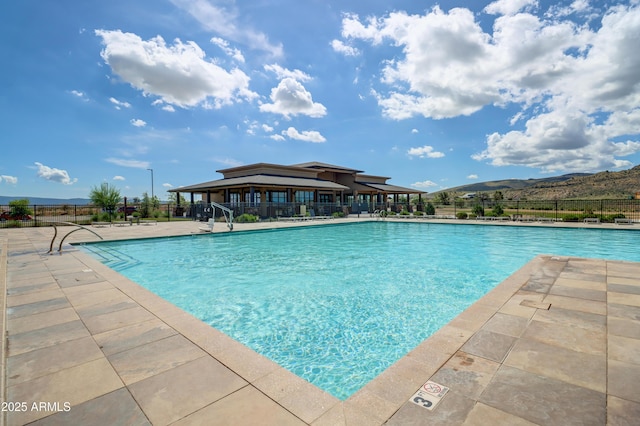 view of swimming pool featuring a mountain view and a patio