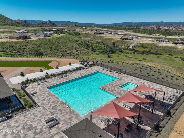 view of swimming pool with a mountain view