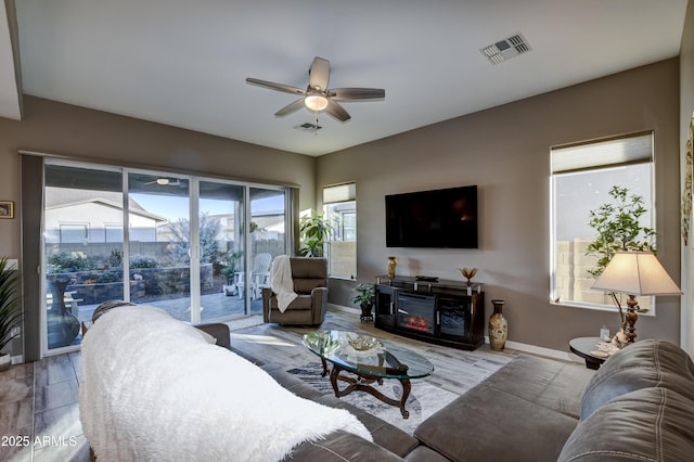 living room with ceiling fan and hardwood / wood-style floors