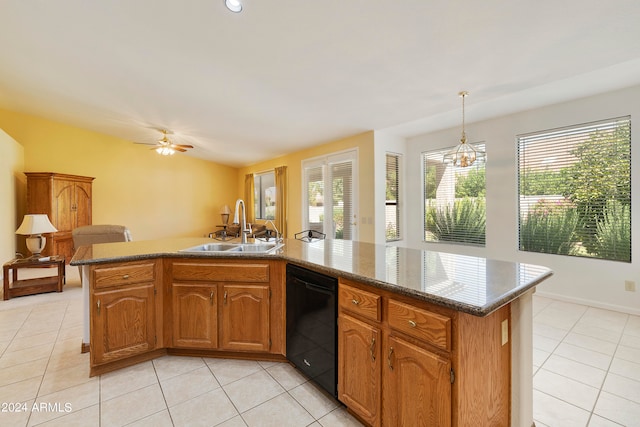 kitchen featuring ceiling fan with notable chandelier, black dishwasher, a kitchen island, and sink