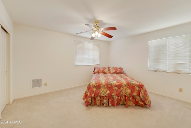 bedroom with light carpet and ceiling fan