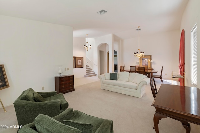 living room featuring light carpet and an inviting chandelier