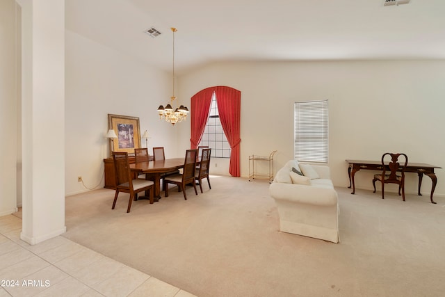 carpeted dining space featuring vaulted ceiling and a chandelier