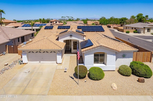 view of front of home featuring solar panels and a garage