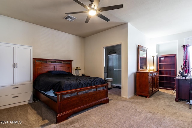 bedroom with light colored carpet, visible vents, ceiling fan, and ensuite bathroom