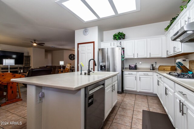 kitchen featuring appliances with stainless steel finishes, range hood, white cabinets, and light tile patterned floors