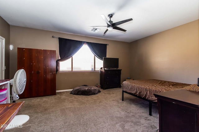 carpeted bedroom with visible vents and a ceiling fan