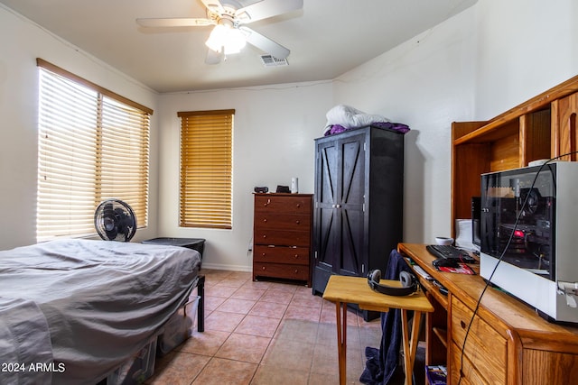 bedroom featuring light tile patterned floors, visible vents, and a ceiling fan