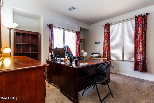 home office featuring light colored carpet, visible vents, and baseboards