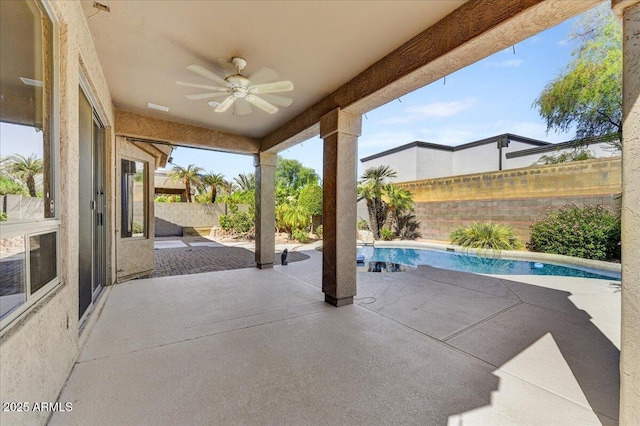 view of patio / terrace with ceiling fan and a fenced in pool