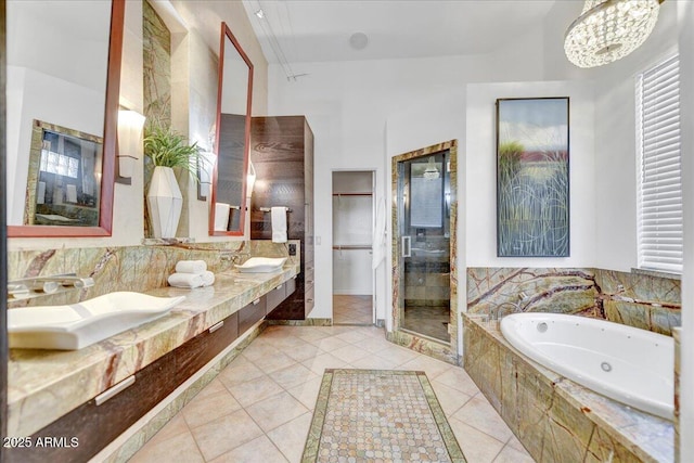 bathroom featuring plus walk in shower, tile patterned flooring, and vanity