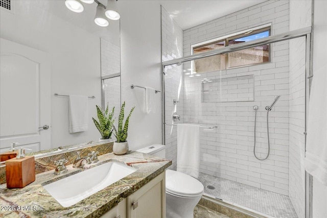 bathroom featuring toilet, walk in shower, and vanity