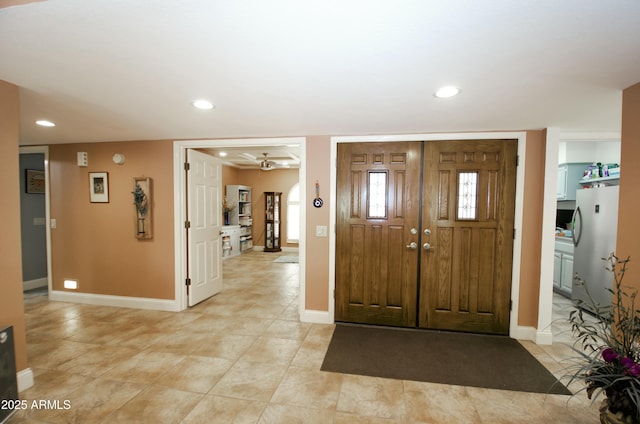 foyer with recessed lighting and baseboards