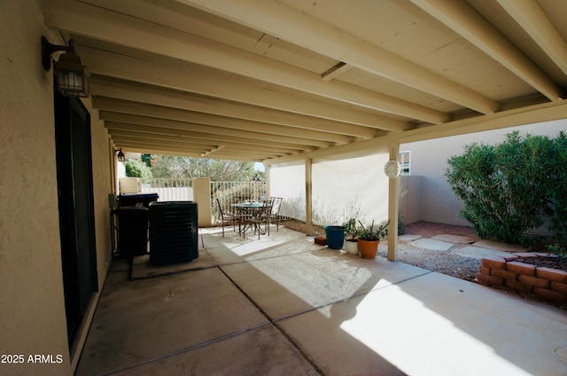 view of patio with outdoor dining area and fence