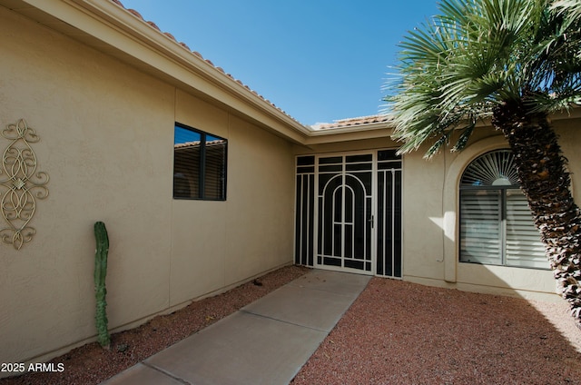 property entrance featuring stucco siding