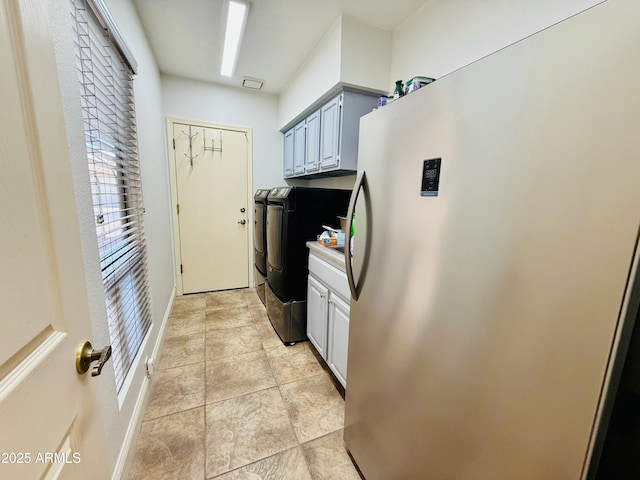 washroom with cabinet space and independent washer and dryer