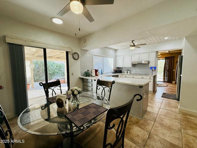 dining room featuring ceiling fan and baseboards