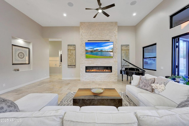 living room featuring a brick fireplace and ceiling fan